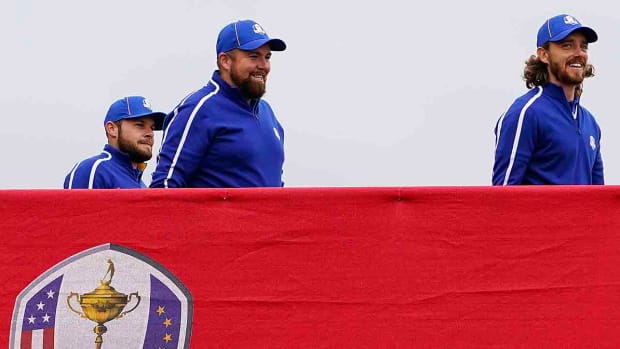 Team Europe players Tyrrell Hatton (left), Shane Lowry (center) and Tommy Fleetwood cross the bridge to the 10th tee during practice rounds for the 2021 Ryder Cup at Whistling Straits.